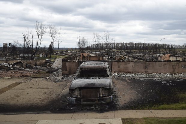 A burned-out vehicle in the Beacon Hill neighbourhood of Fort McMurray. Photograph: Ryan Remiorz/AP